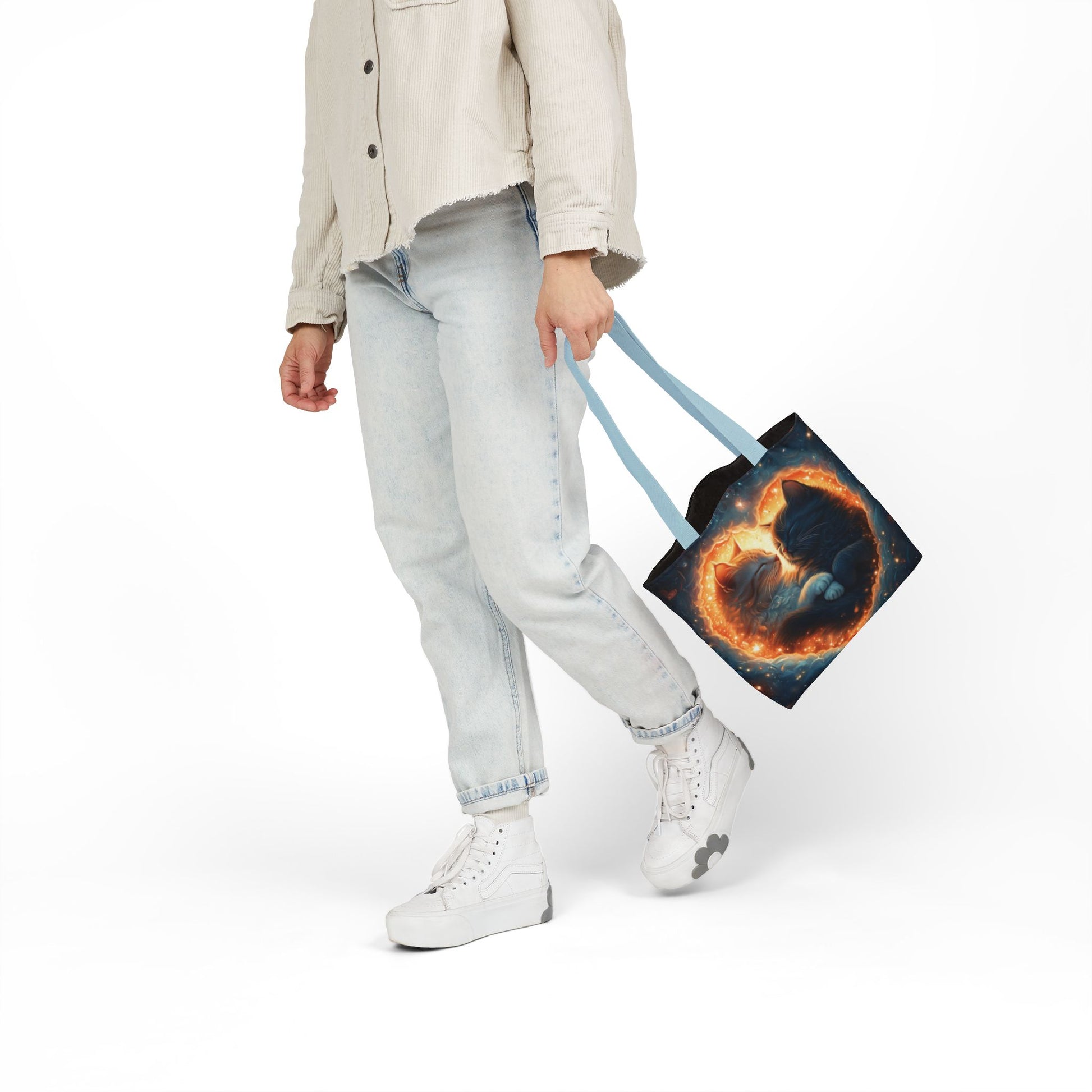 A vibrant heart composed of swirling stardust cradles two cuddling cats against a backdrop of a deep, colorful galaxy. This all-over print design covers the entirety of the Celestial Embrace Tote Bag.
