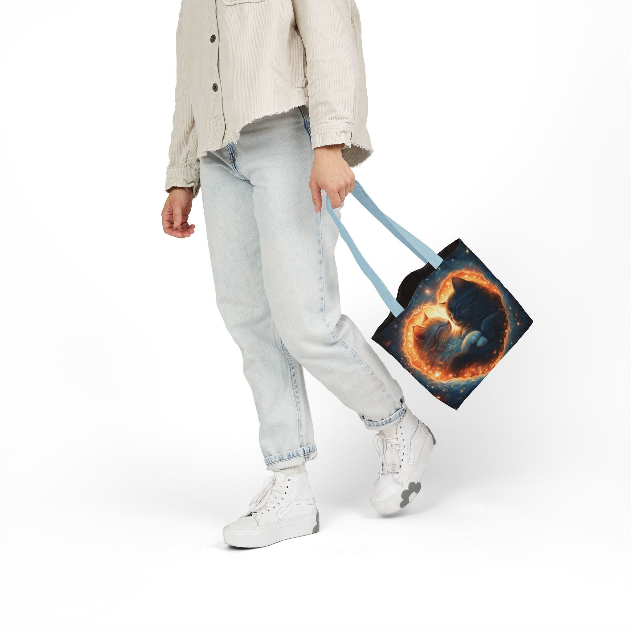 A vibrant heart composed of swirling stardust cradles two cuddling cats against a backdrop of a deep, colorful galaxy. This all-over print design covers the entirety of the Celestial Embrace Tote Bag.
