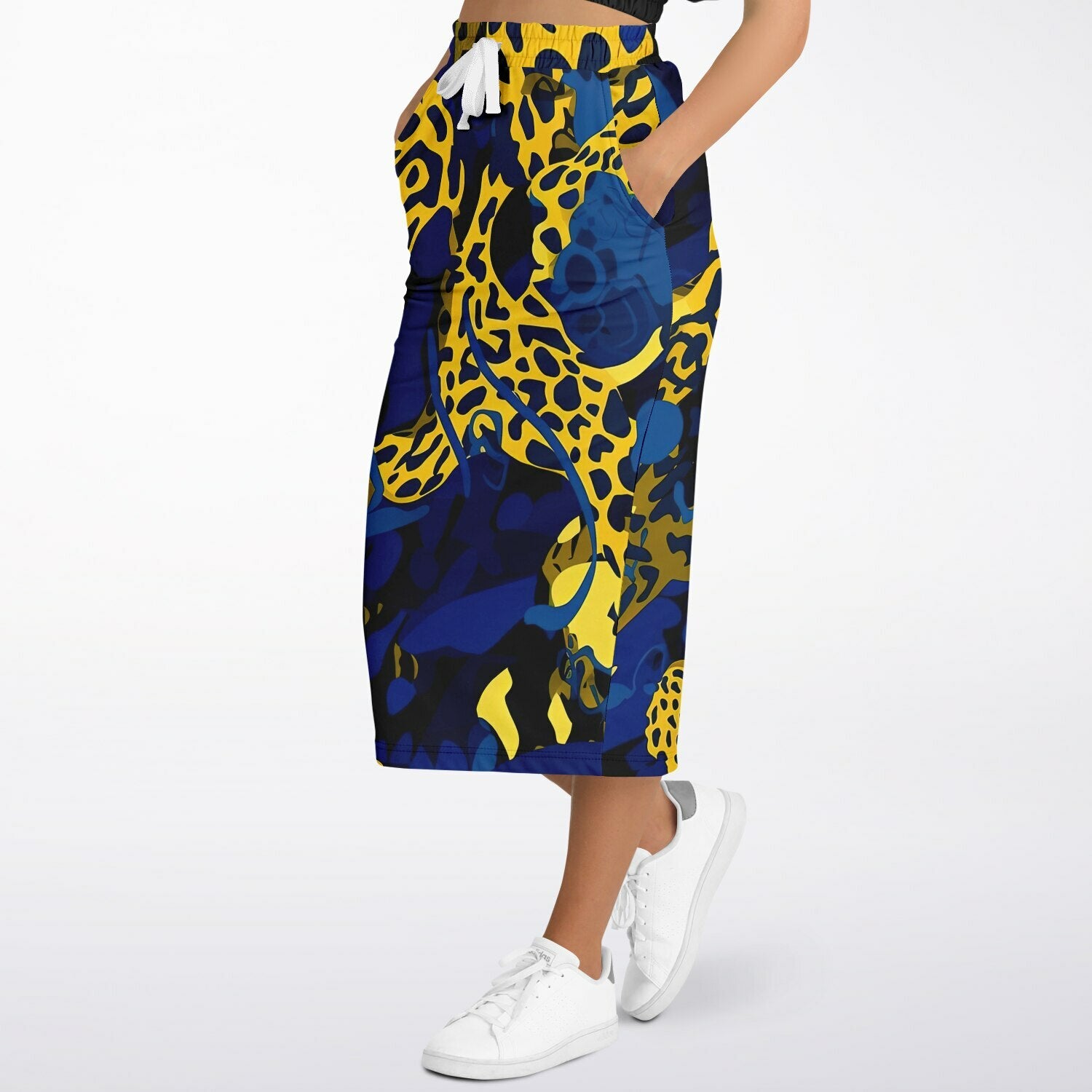 A long athletic skirt with vibrant leopard print and blue color, featuring side pockets and a drawstring closure.
