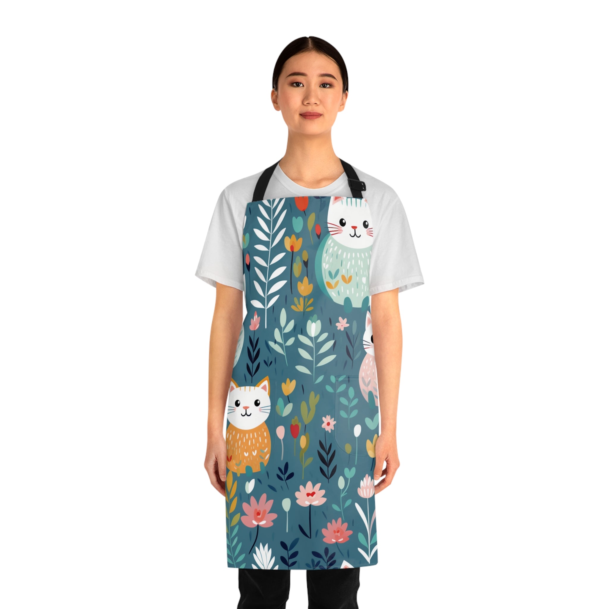 Model wearing a colorful apron with cat and floral design