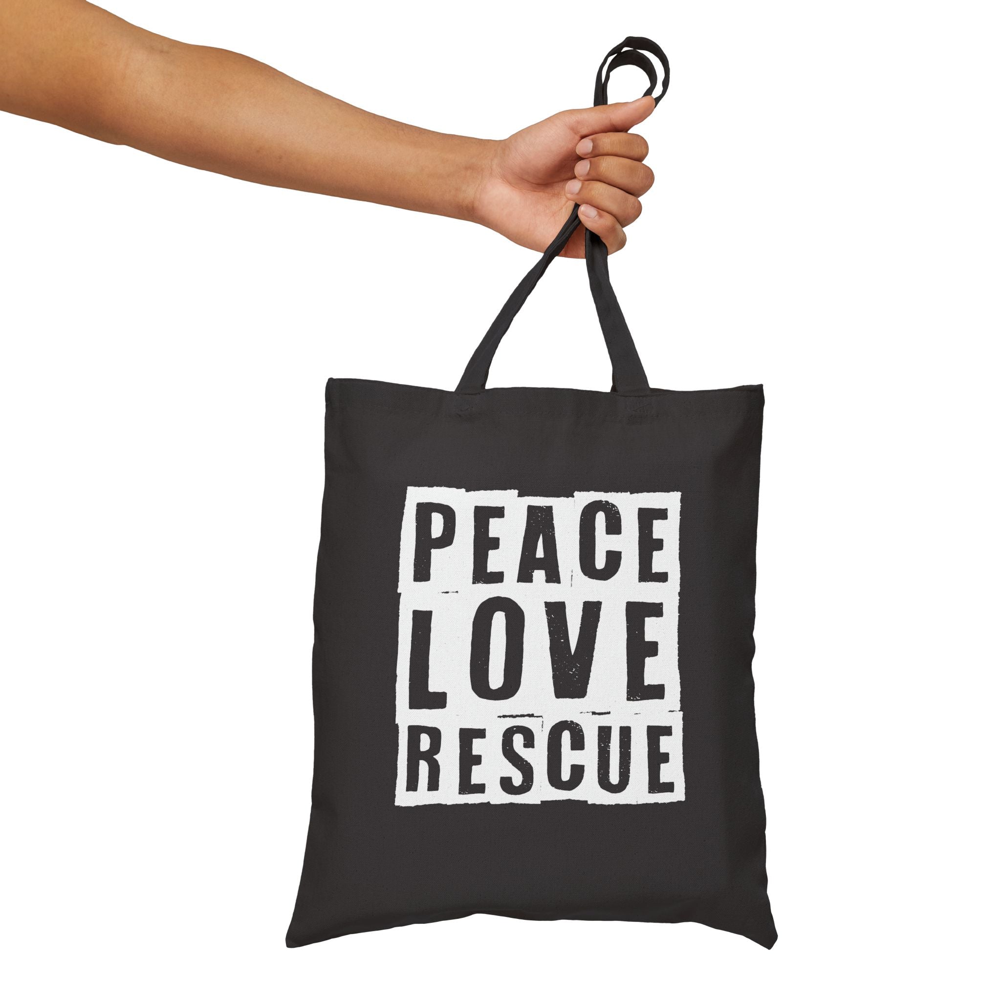 Black canvas tote with Peace Love Rescue graphic held by handles, front view