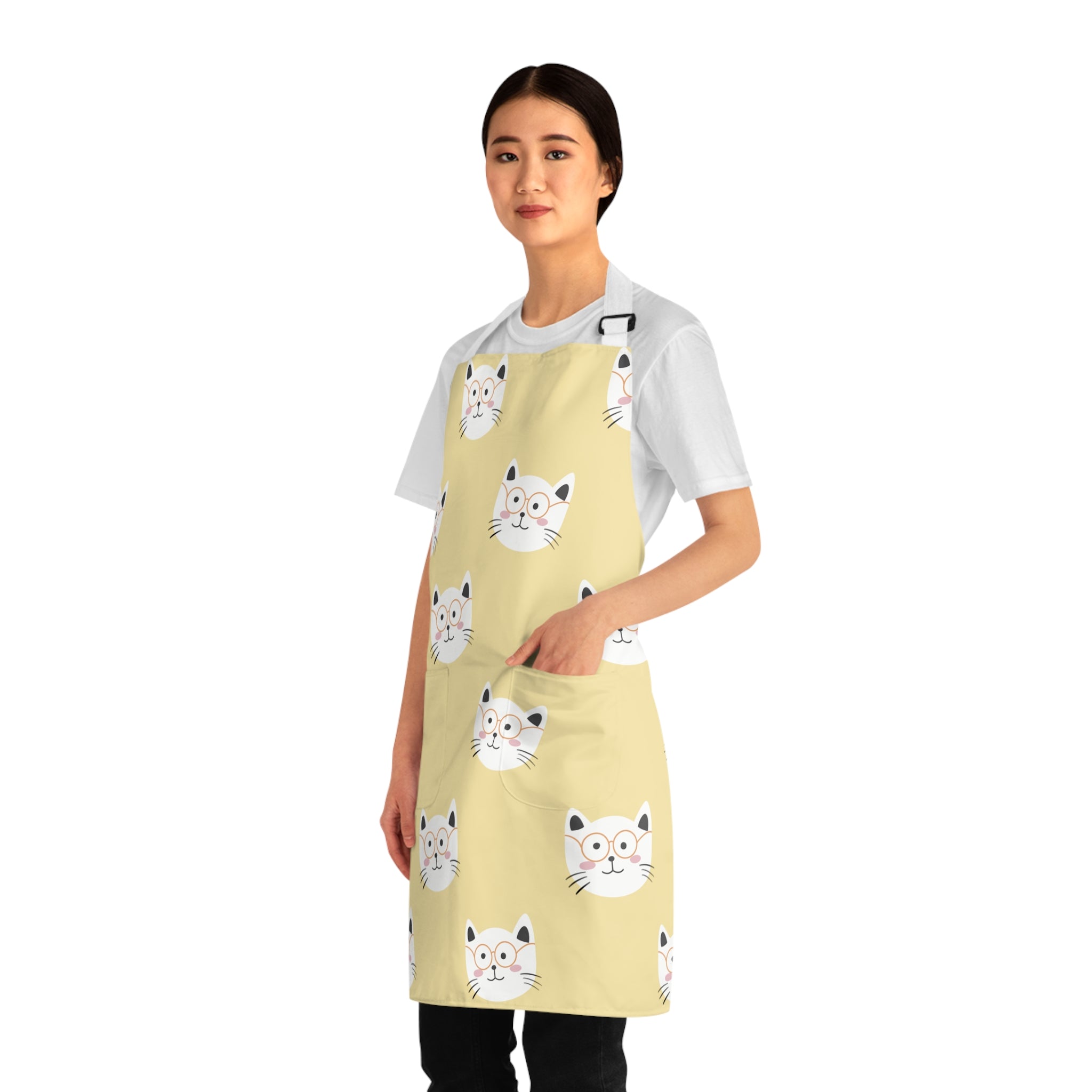 Model wearing a yellow apron with smiling cat pattern