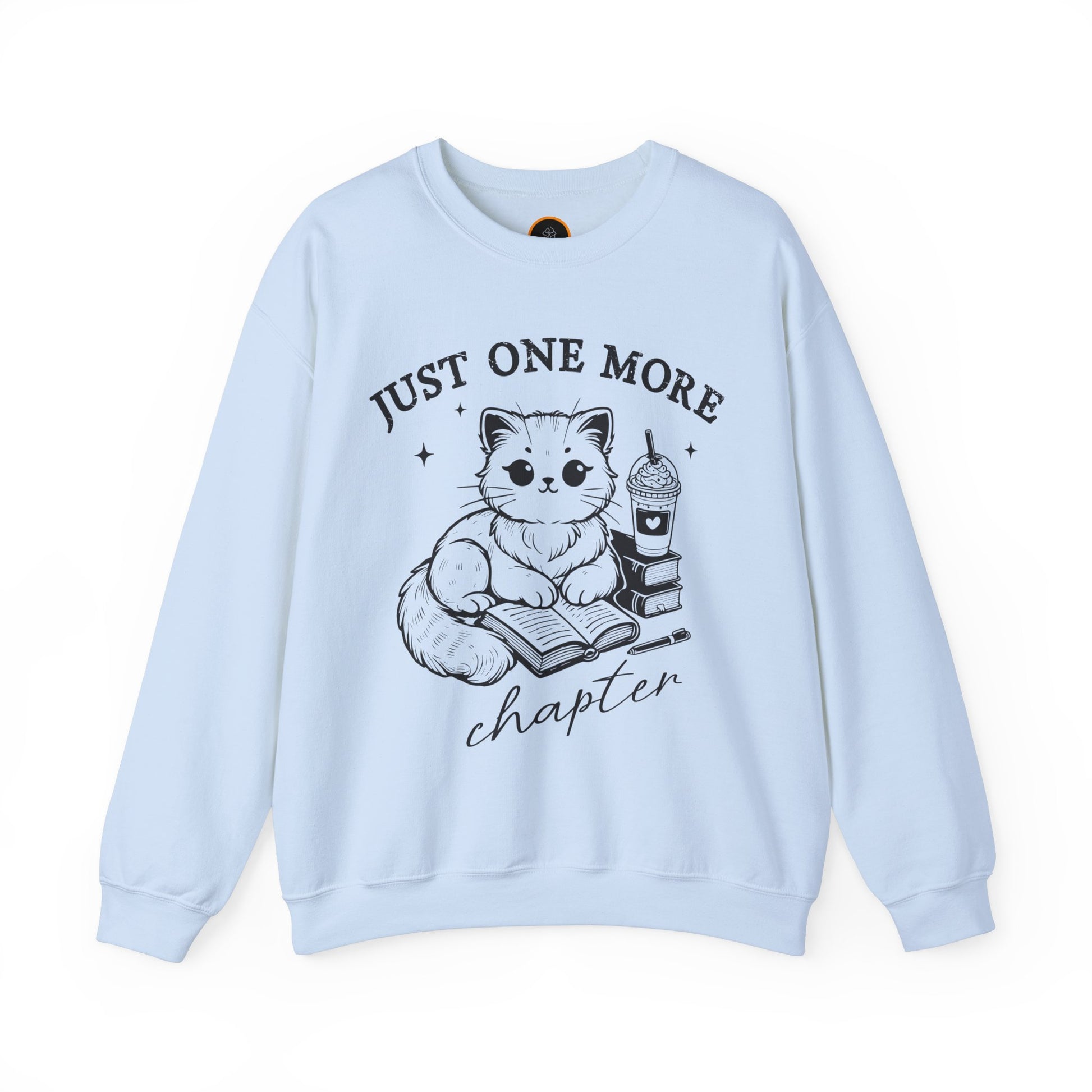 Just One More Chapter" light gray crewneck sweatshirt with a graphic of a cat reading a book next to a Frappuccino on a stack of books.
