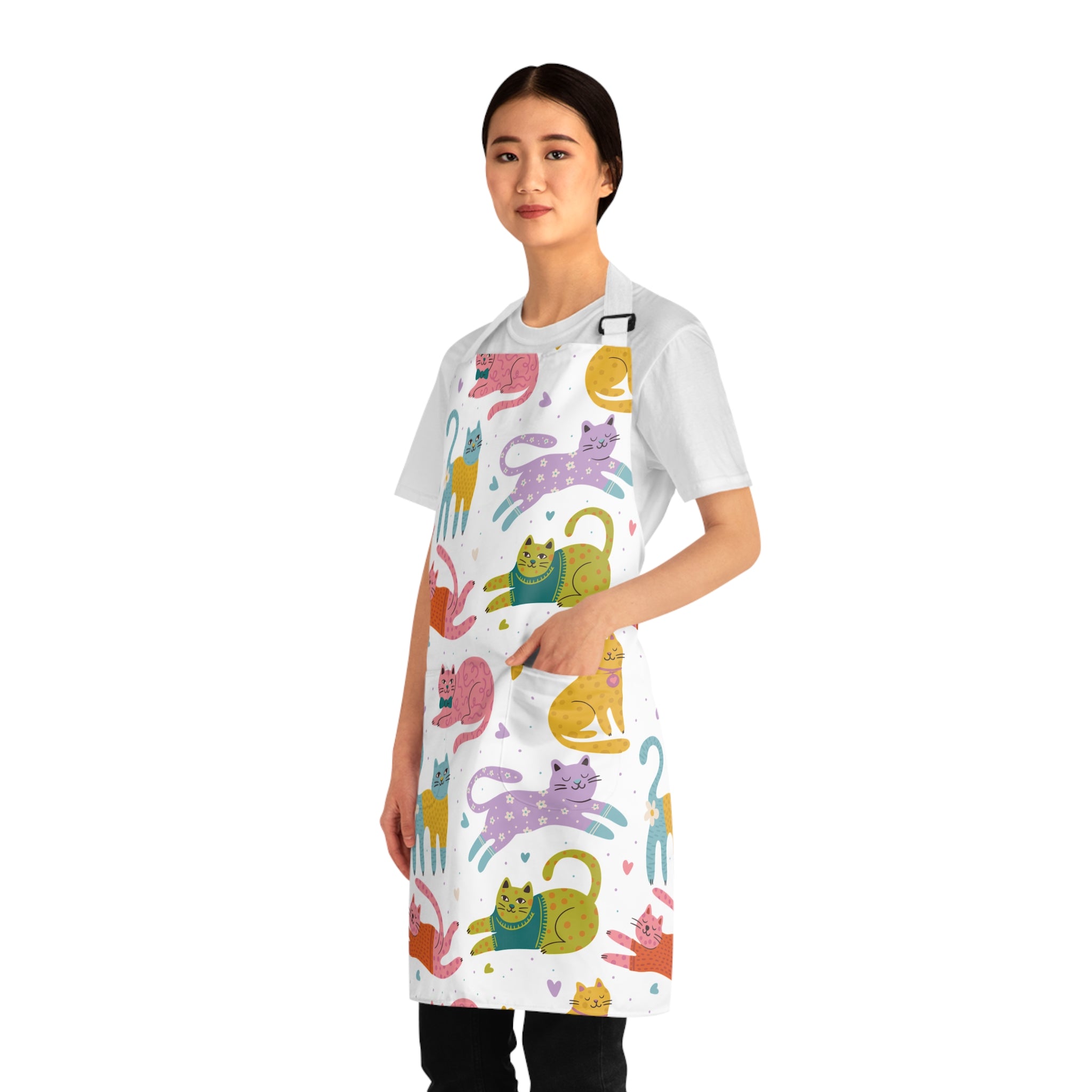 Model wearing a white apron with colorful cat patterns on a white background
