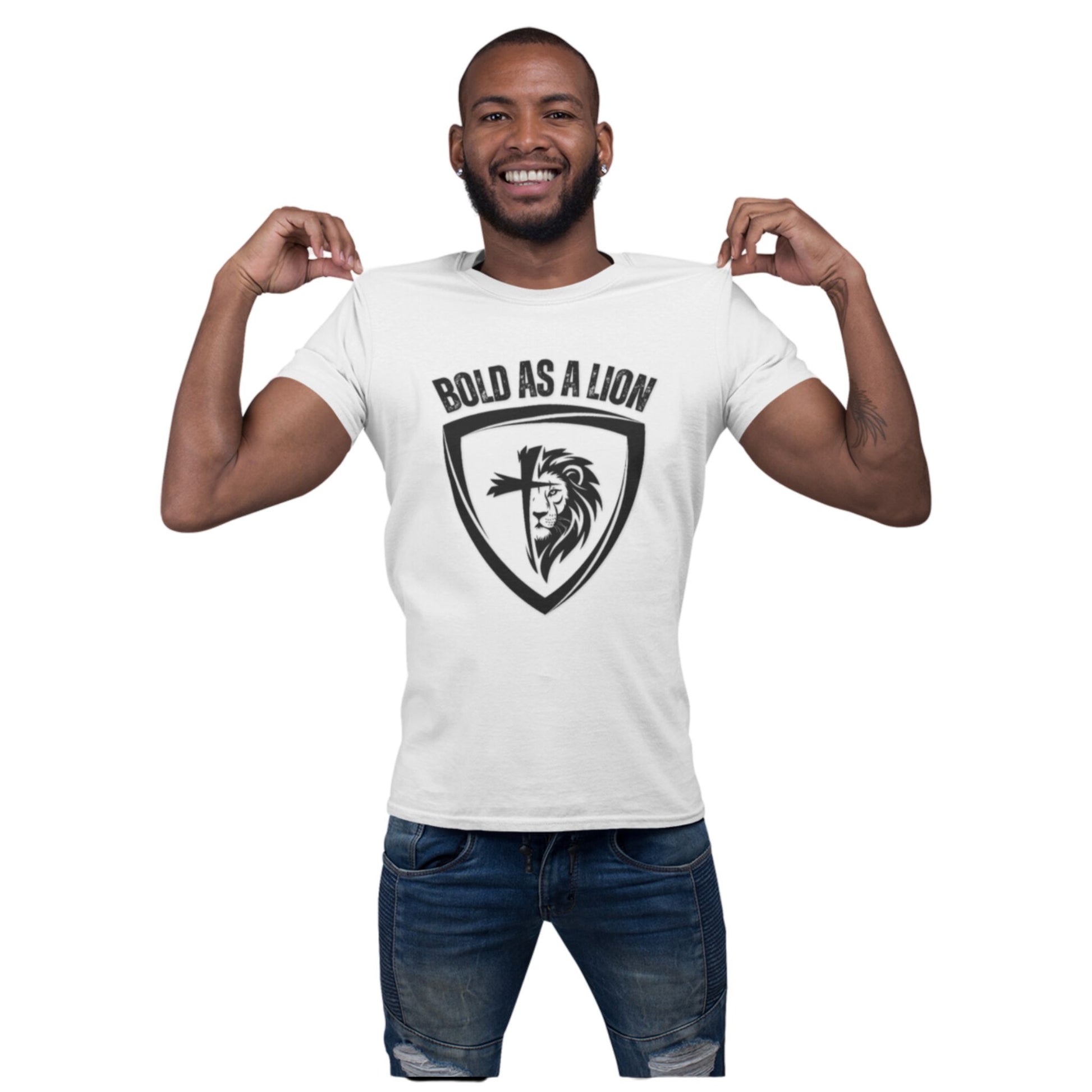 A man models the Bold As A Lion tee. The t-shirt features a graphic with half of a lion's face merging into half of a cross within a shield outline. The text "bold as a lion" is printed above the graphic.