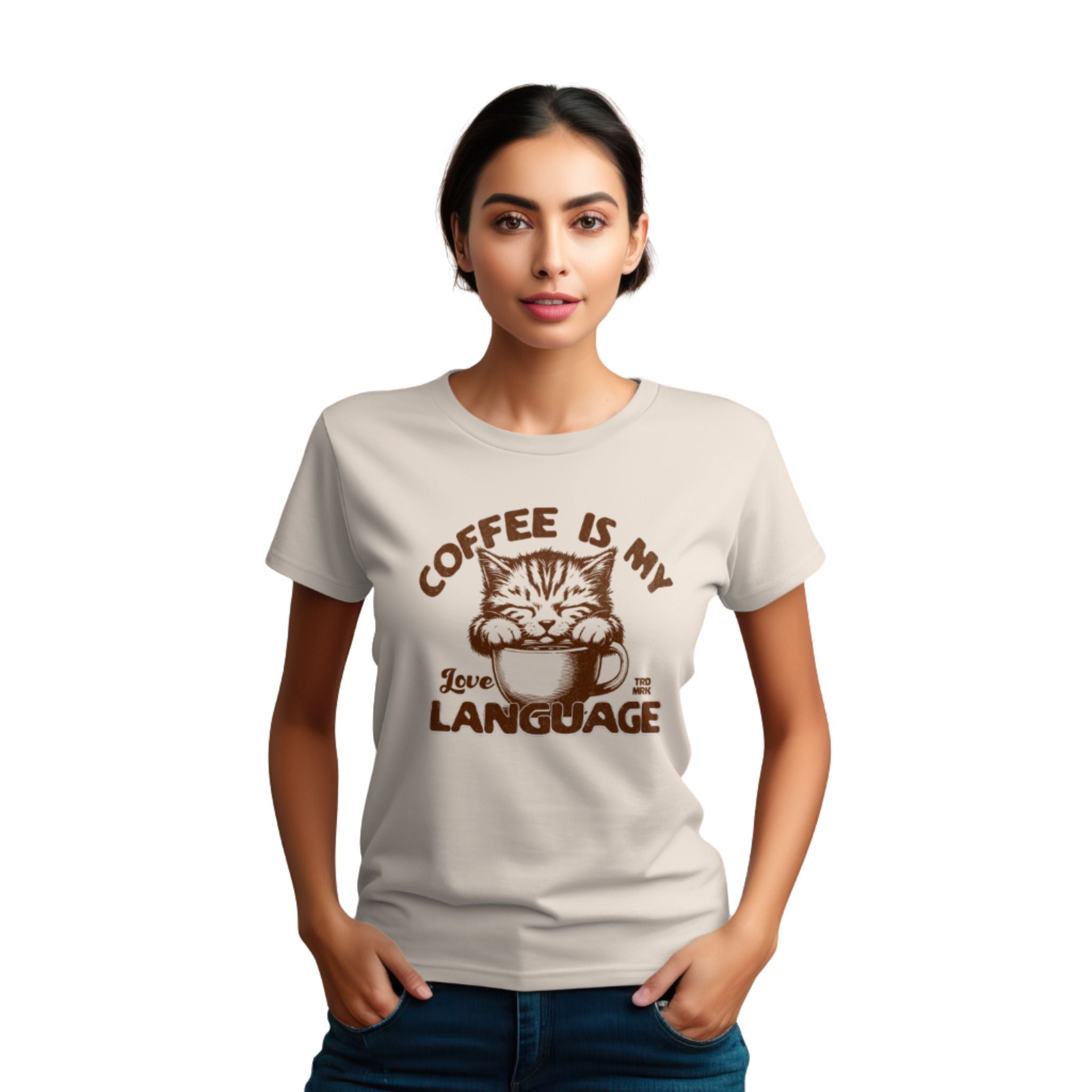 A woman wearing a beige crew neck t-shirt with the text 'COFFEE IS MY LANGUAGE' and a graphic of a cat.