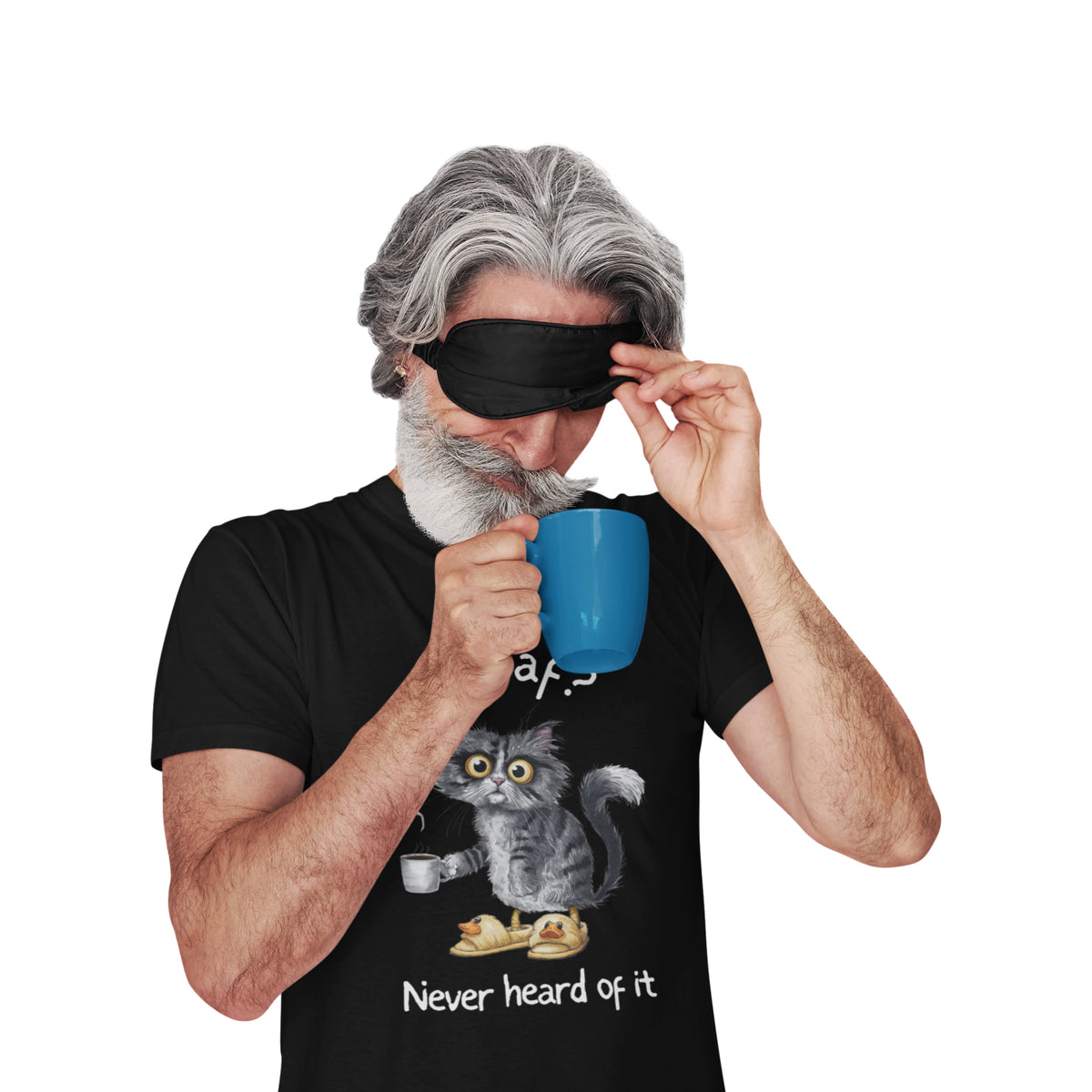 A man with gray hair and a beard wearing a black sleep mask and a black graphic t-shirt, holding a blue mug. The t-shirt features a cartoon of a gray cat with yellow eyes drinking from a cup and the text 'Never heard of it'.