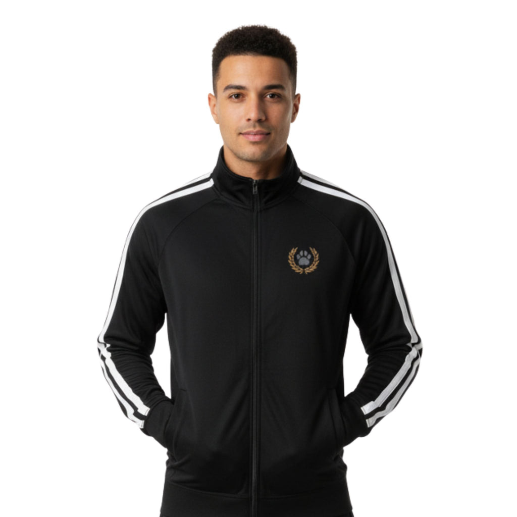 A model wearing a black track jacket with white arm stripes and an orange wreath crest surrounding a grey cat's paw.