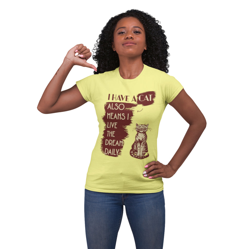 Woman wearing a yellow t-shirt featuring a happy, grinning cat graphic and the quote, "I have a cat also means I live the dream daily."