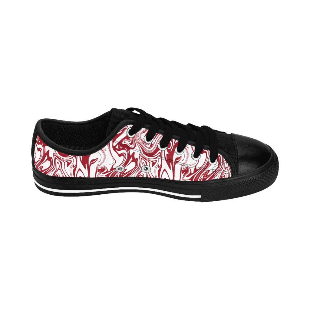 Inside view of the Candy Swirl women's sneakers: white with red swirl all-over print, two black paw prints on heel.
