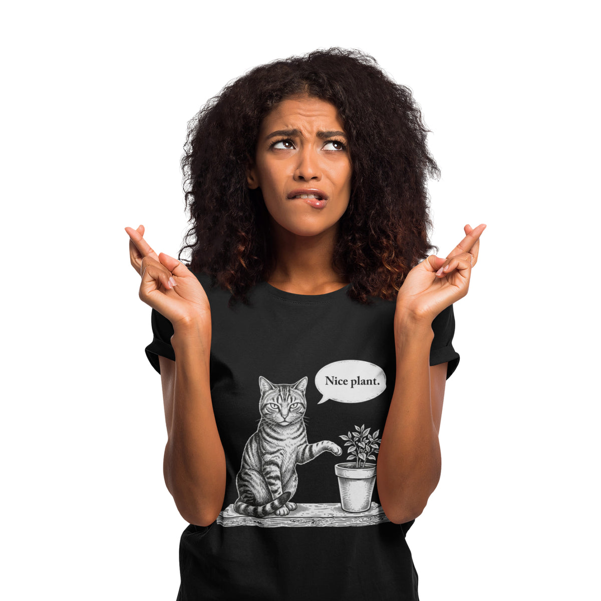 A woman with curly dark hair wearing a black graphic t-shirt. The shirt features a black and white illustration of a cat sitting next to a small potted plant with a speech bubble that says 'Nice plant.