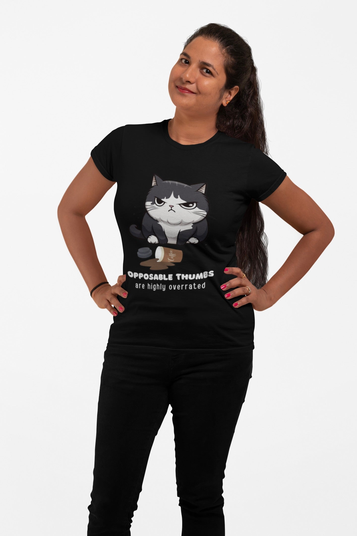 A woman modeling a black short-sleeve graphic t-shirt with a cartoon cat and the text 'OPPOSABLE THUMBS are highly overrated' on the front, paired with black pants against a plain white background.