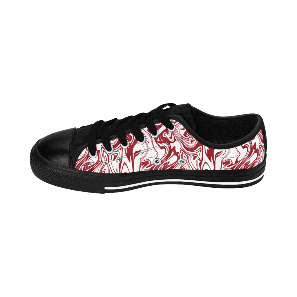 Inside view of the Candy Swirl women's sneakers: white with red swirl all-over print, two black paw prints on heel.