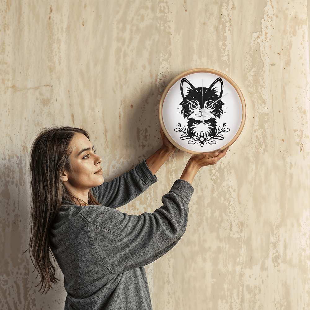 Black and white line art of a kitten sitting among flowers on a 10" wood frame "Purfect Timing" clock.