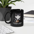 Black glossy mug with a graphic of a frustrated cartoon cat standing over spilled coffee. Text below the cat reads "Opposable Thumbs Are Highly Overrated".