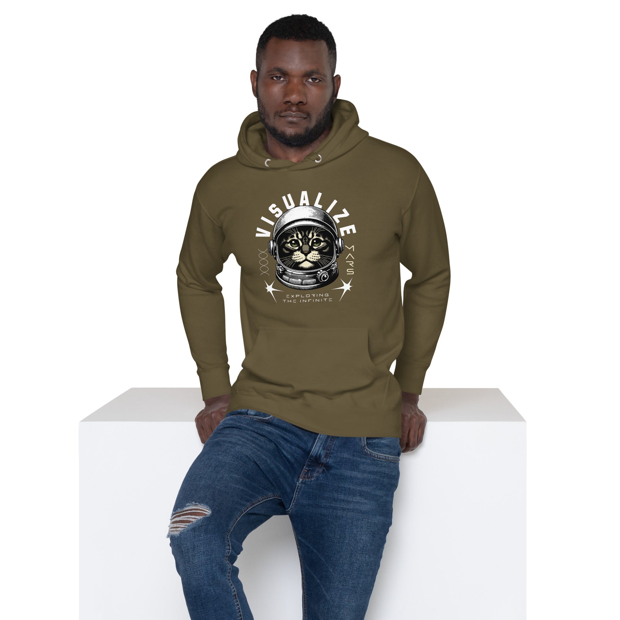 A male model wears an olive hoodie featuring a graphic of a cat wearing a space helmet. The text above the graphic reads, "VISUALIZE MARS," with the sub-text, "EXPLORE THE INFINITE.