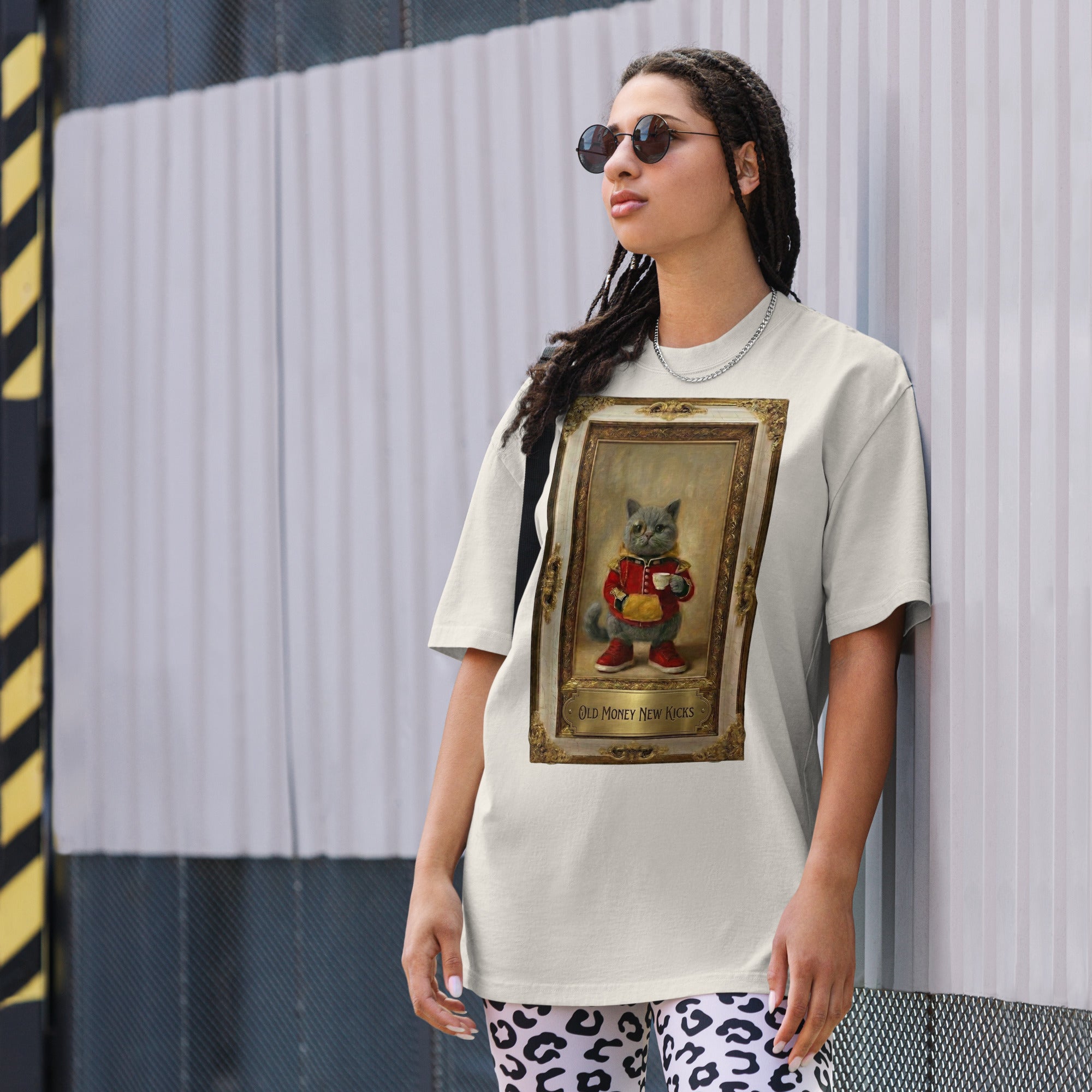 Model wearing white oversized faded tee with vintage portrait graphic, street view