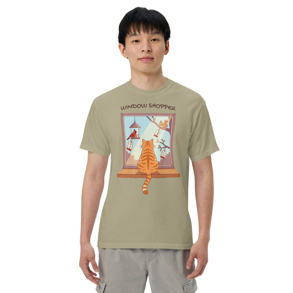 A model wearing the Khaki Window Shopper heavyweight t-shirt with an orange cat on a windowsill