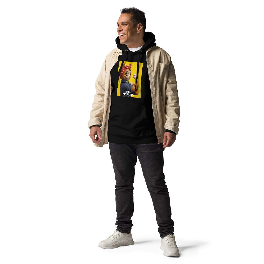 Model wearing black Still Fighting Hoodie layered under tan jacket, front view