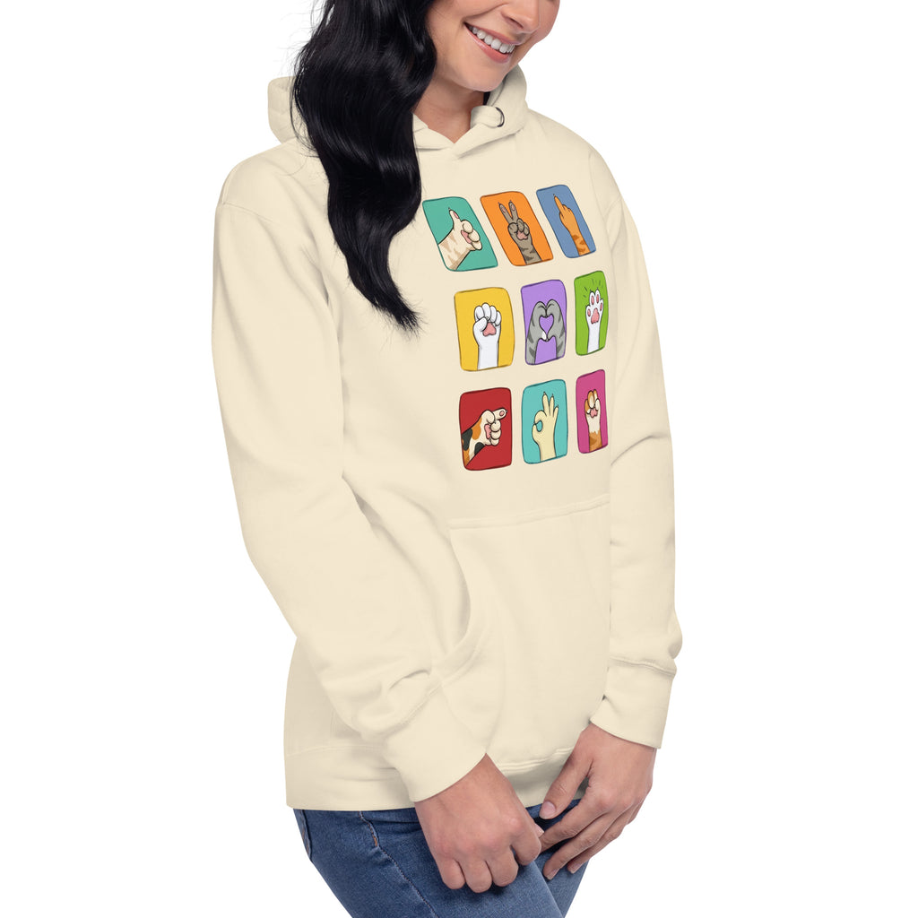 Model wearing cream hoodie with colorful paw signals grid graphic, close-up