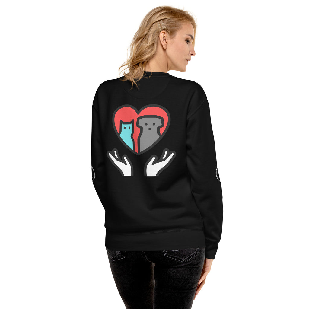 Back of sweatshirt: Graphic depicts two hands holding up a cat and a dog together inside a heart.