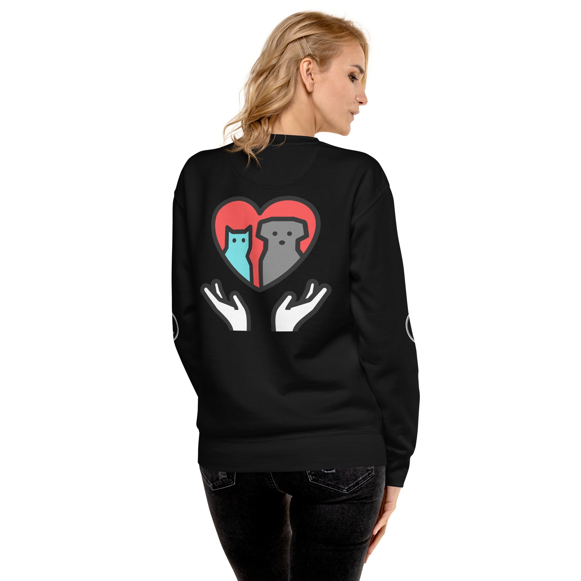 Back of sweatshirt: Graphic depicts two hands holding up a cat and a dog together inside a heart.