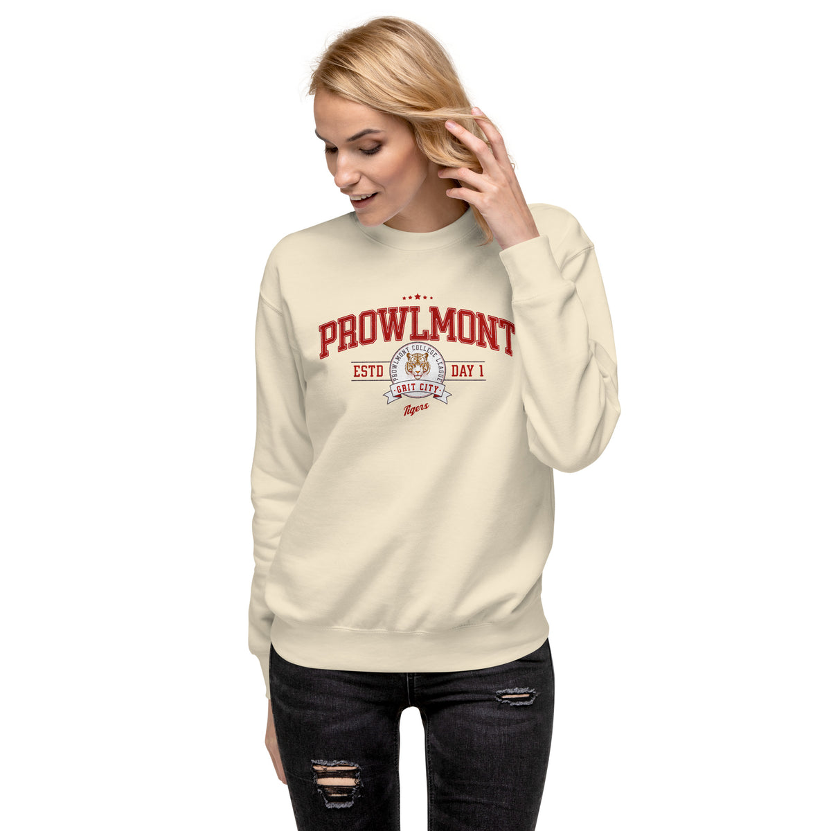 Model wearing a cream-colored varsity sweatshirt with yellow 'Prowlmont Grit City Tigers' tiger graphic