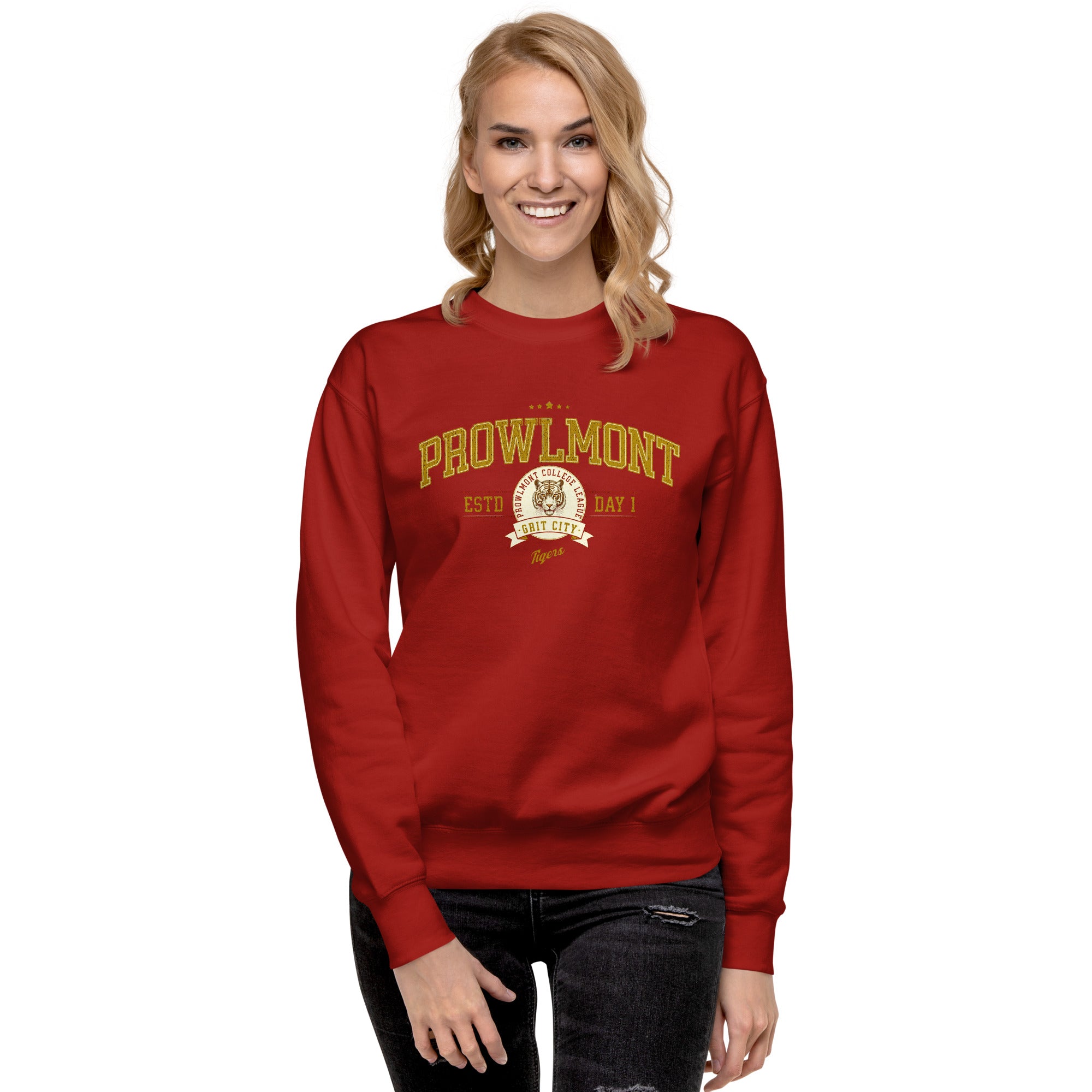 Woman wearing a red varsity style sweatshirt with yellow 'Prowlmont Grit City Tigers' text and tiger logo on a white background