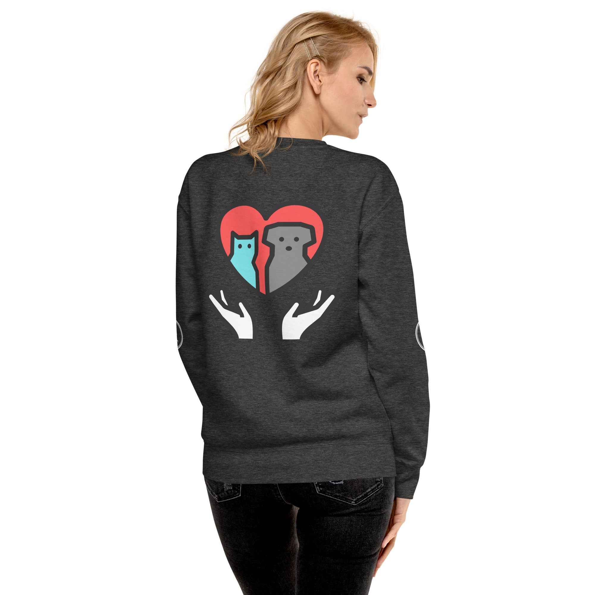 Back of sweatshirt: Graphic depicts two hands holding up a cat and a dog together inside a heart.