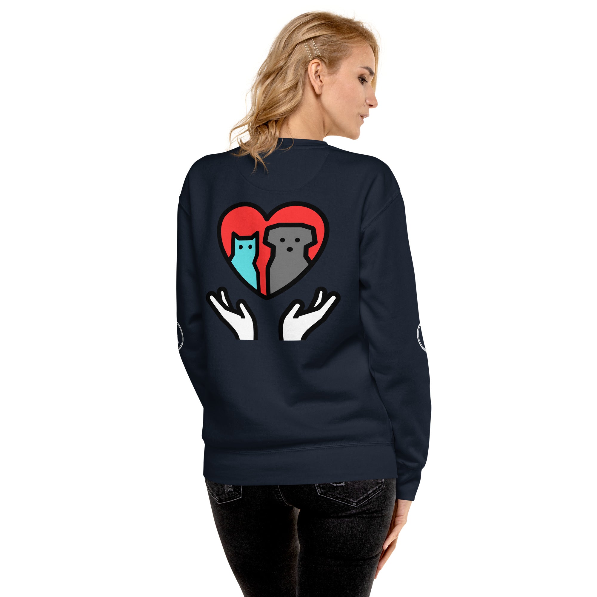 Back of sweatshirt: Graphic depicts two hands holding up a cat and a dog together inside a heart.