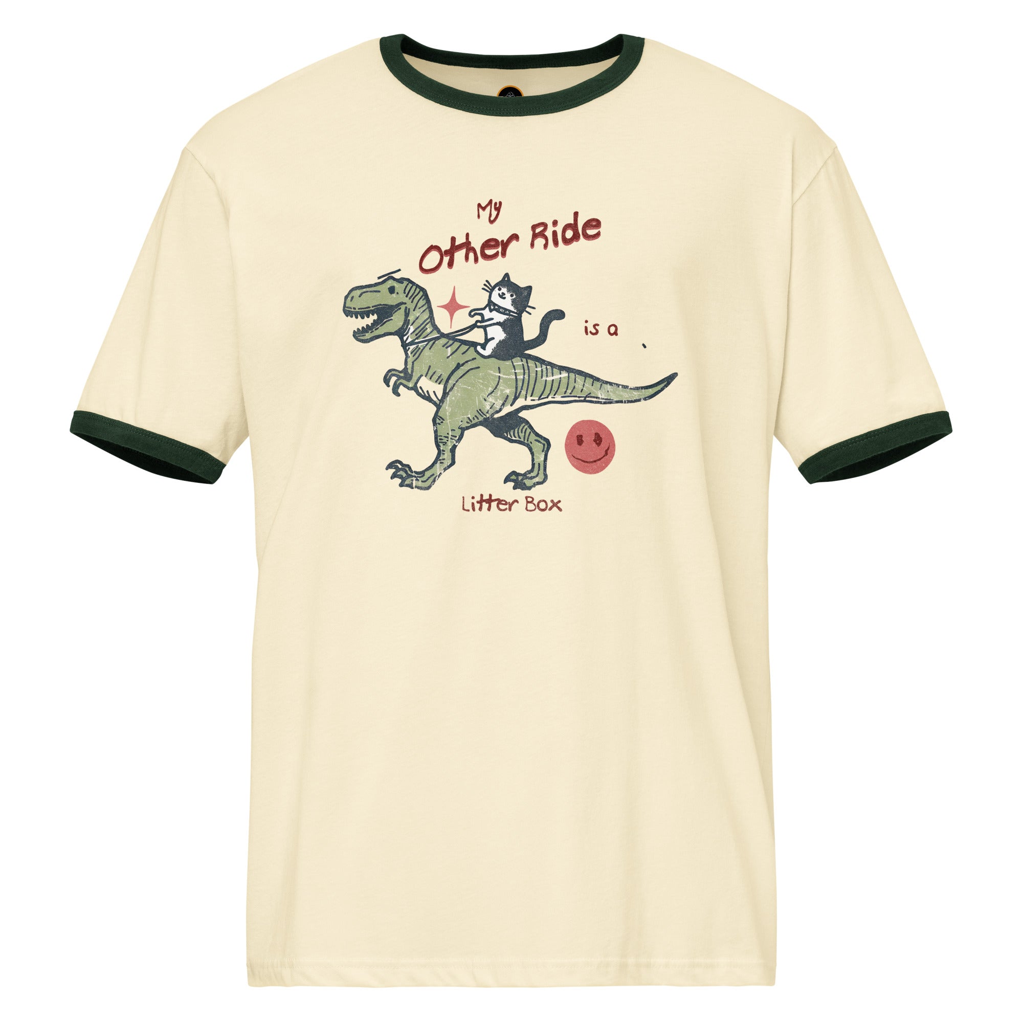 Beige ringer t-shirt with a cat riding a dinosaur  graphic. The text reads 'My other ride is a litter box'.