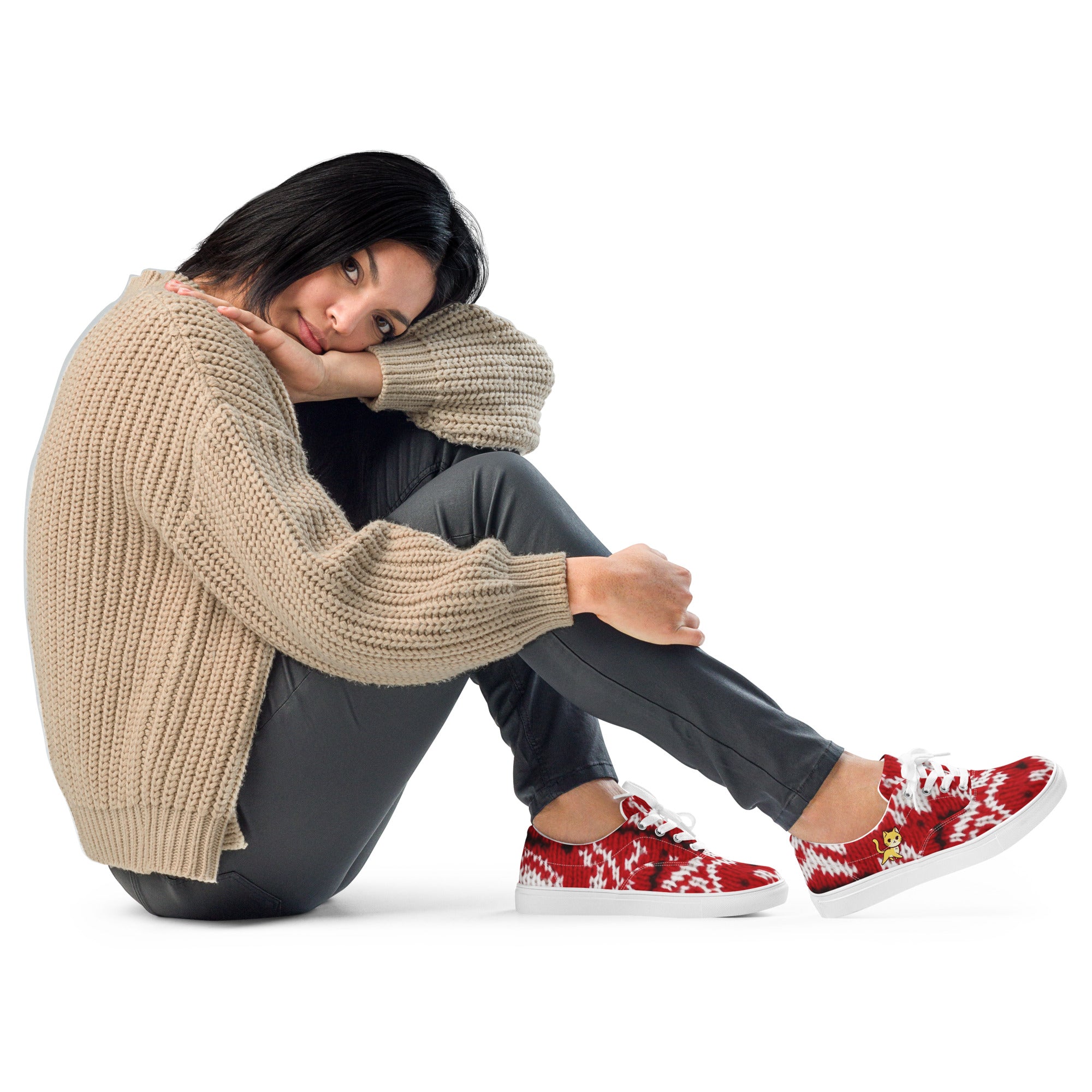 A woman wearing low-top 'Knitty Kitty' sneakers featuring a vibrant red and white knit pattern and a playful yellow cat design.